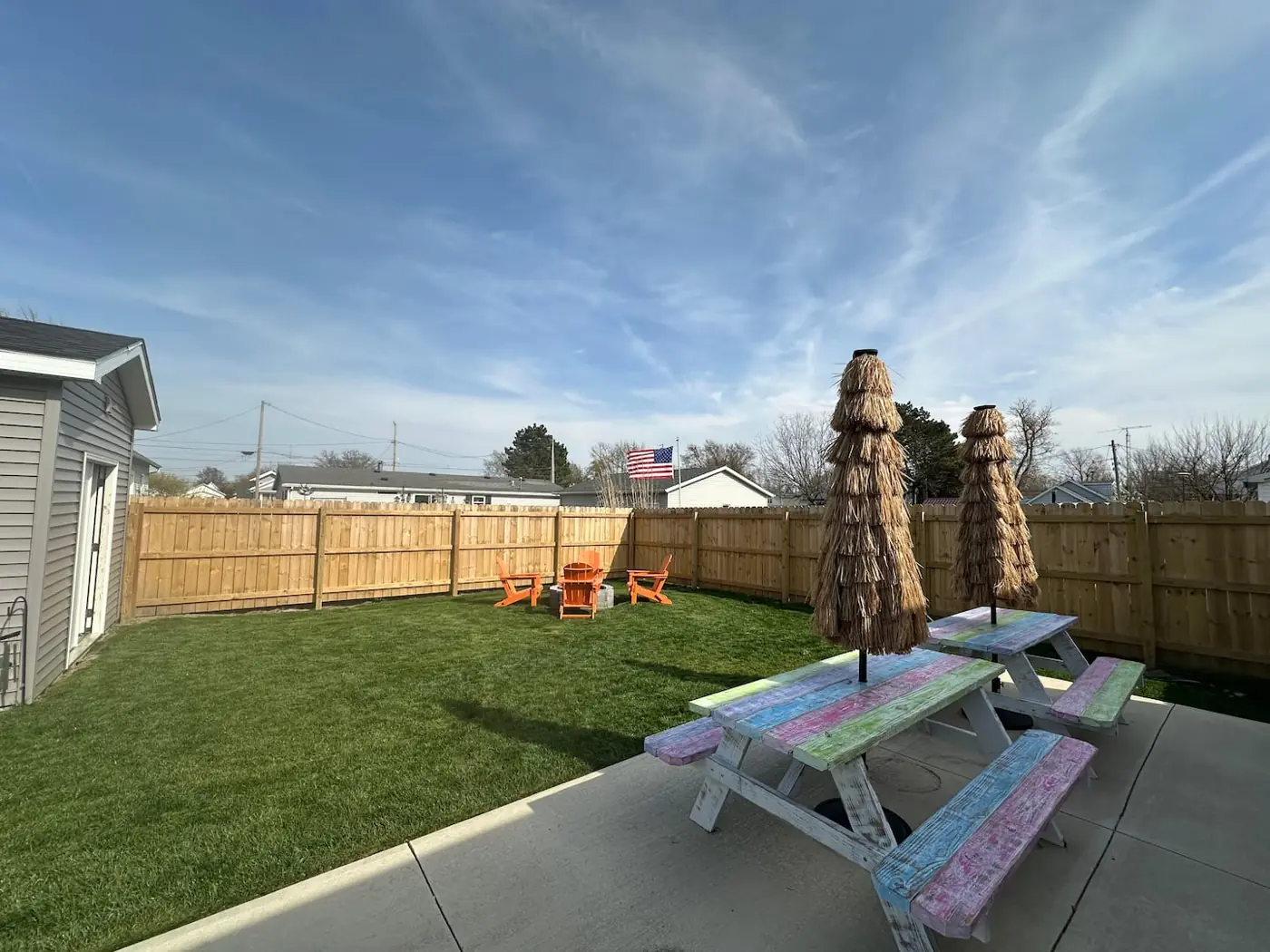 Backyard with picnic tables and umbrellas – Port Clinton vacation rental