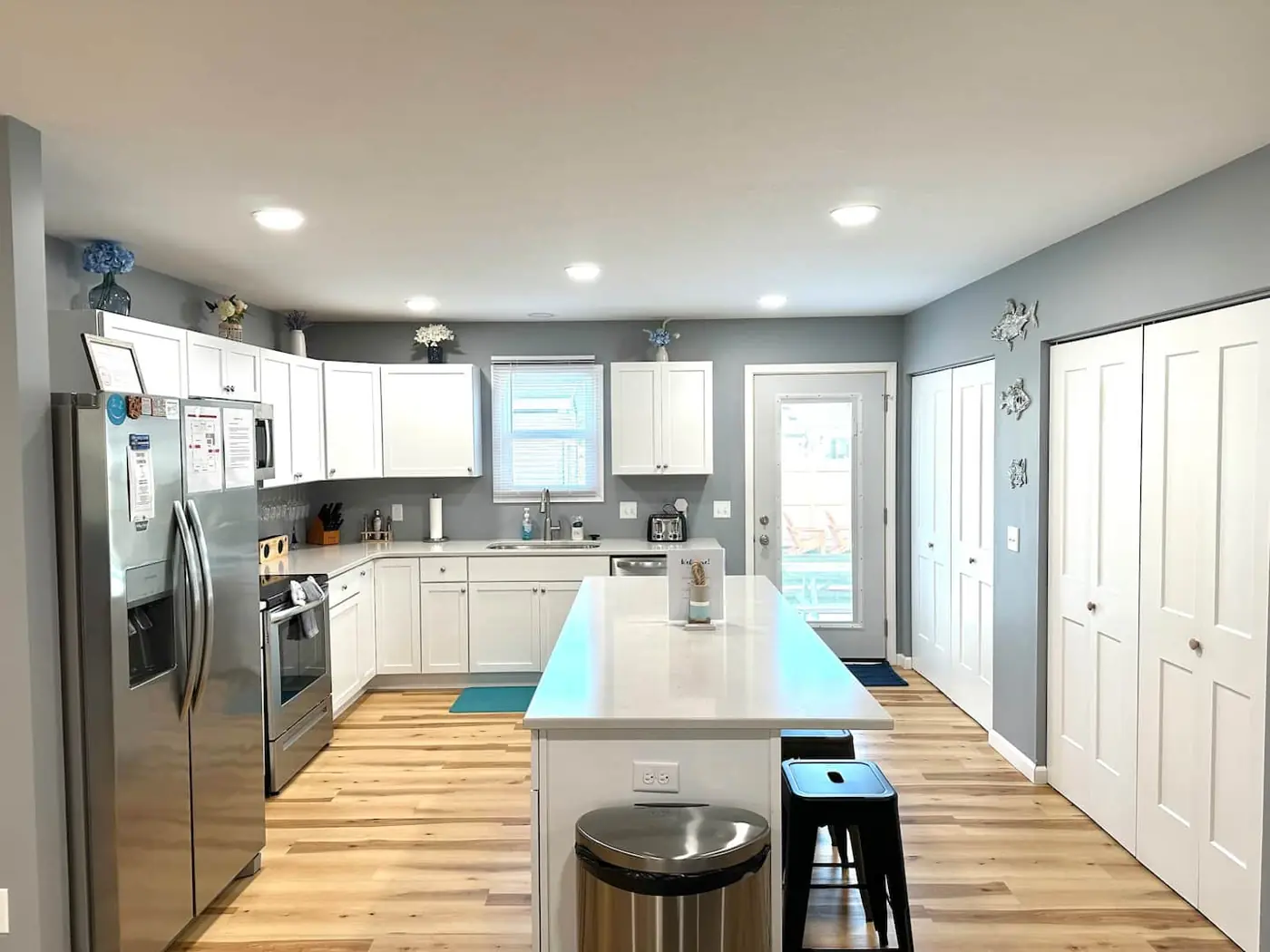 Full kitchen view with island and refrigerator – Port Clinton vacation rental