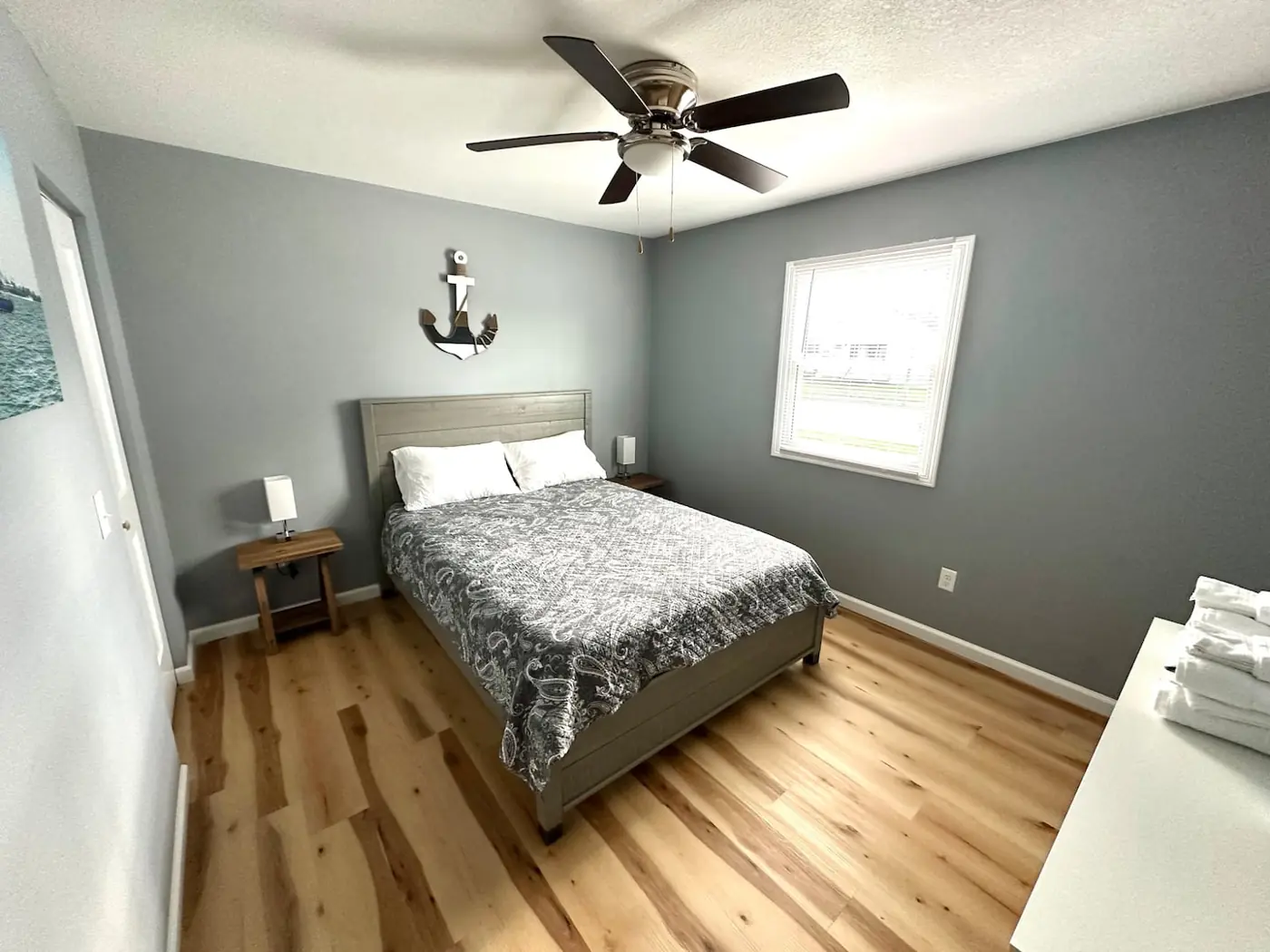 Bedroom 1 queen bed with gray walls, ceiling fan and two nightstands – Port Clinton vacation rental