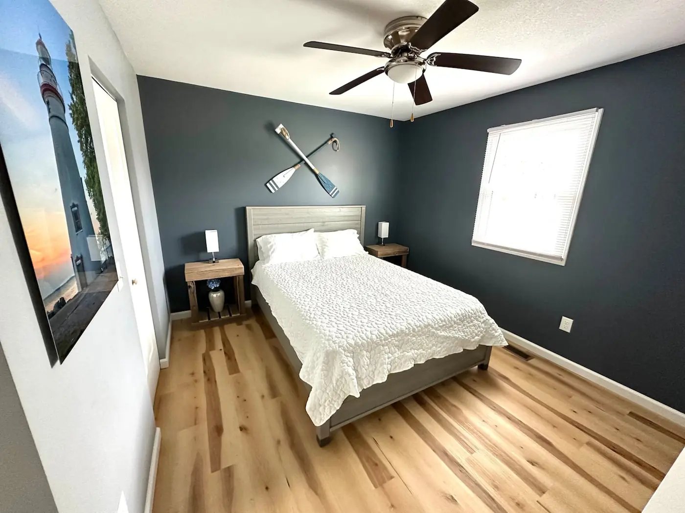 Bedroom 3 queen bed with lighthouse art and crossed-oar decor – Port Clinton vacation rental